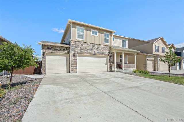 437 Thrush Pl, Johnstown, CO 80534 - view of front of house featuring stone siding, driveway, a porch, a garage, and board and batten siding