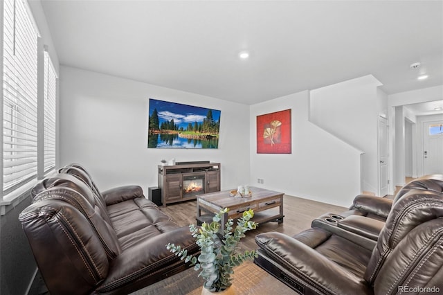 437 Thrush Pl, Johnstown, CO 80534 - living area featuring wood finished floors, recessed lighting, and a glass covered fireplace