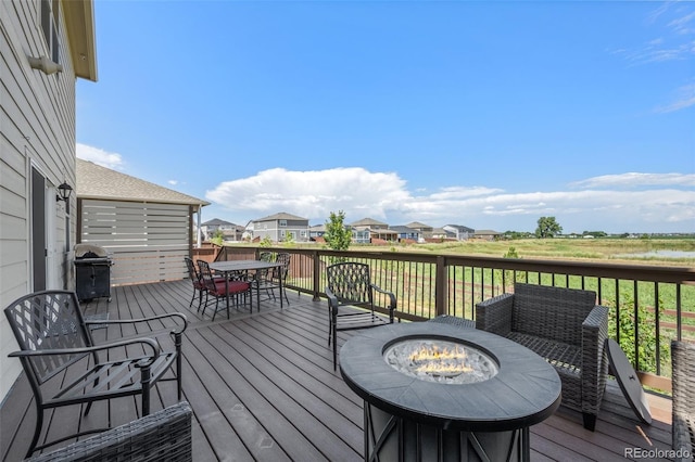 437 Thrush Pl, Johnstown, CO 80534 - deck with outdoor dining space, a residential view, grilling area, and a fire pit
