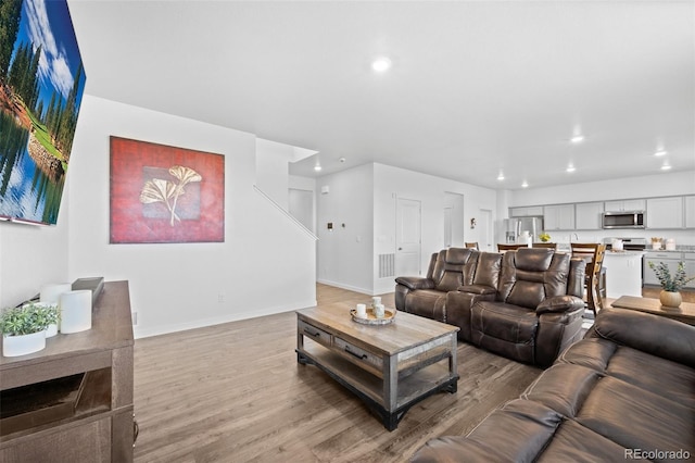 437 Thrush Pl, Johnstown, CO 80534 - living room with light wood-style flooring and recessed lighting