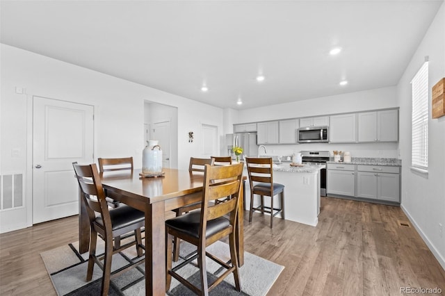 437 Thrush Pl, Johnstown, CO 80534 - dining room with wood finished floors and recessed lighting
