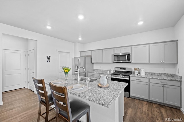 437 Thrush Pl, Johnstown, CO 80534 - kitchen with gray cabinets, stainless steel appliances, dark wood finished floors, and recessed lighting