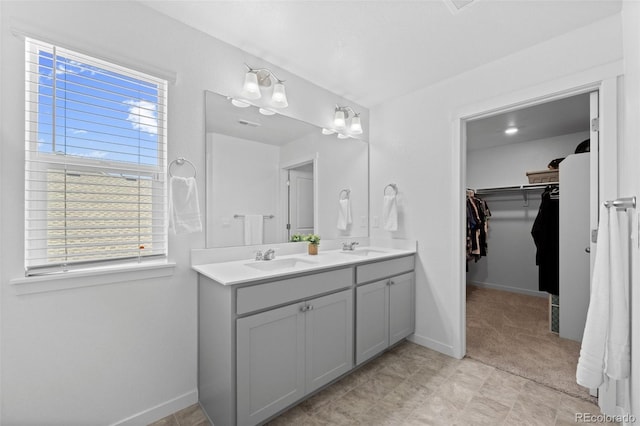 437 Thrush Pl, Johnstown, CO 80534 - bathroom with double vanity, plenty of natural light, and a walk in closet
