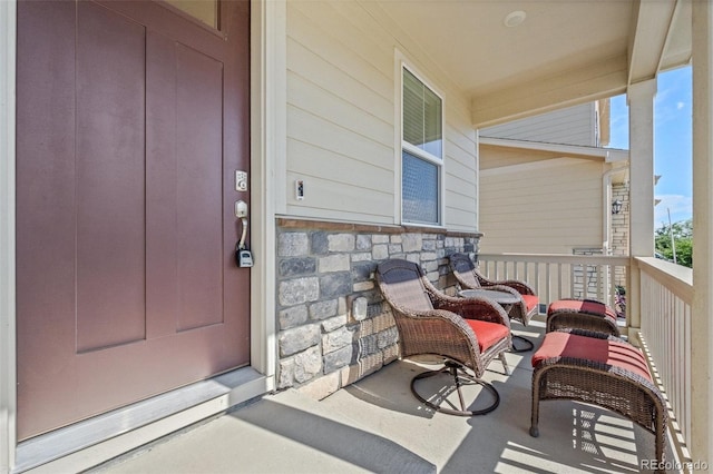 437 Thrush Pl, Johnstown, CO 80534 - doorway to property featuring stone siding and covered porch