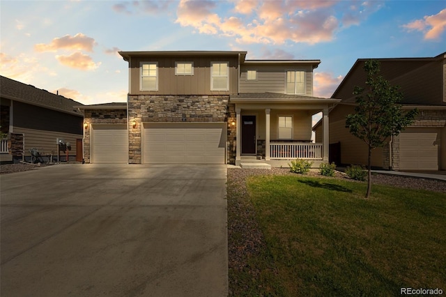 437 Thrush Pl, Johnstown, CO 80534 - view of front facade with a porch, stone siding, concrete driveway, a front lawn, and an attached garage