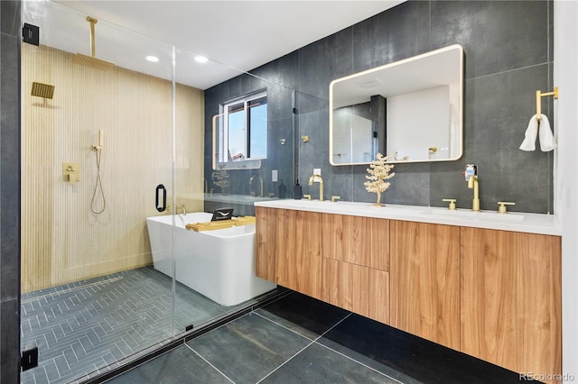 bathroom with independent shower and bath, vanity, and tile patterned floors