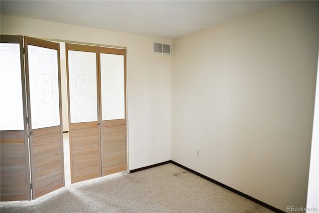 unfurnished bedroom featuring visible vents and baseboards