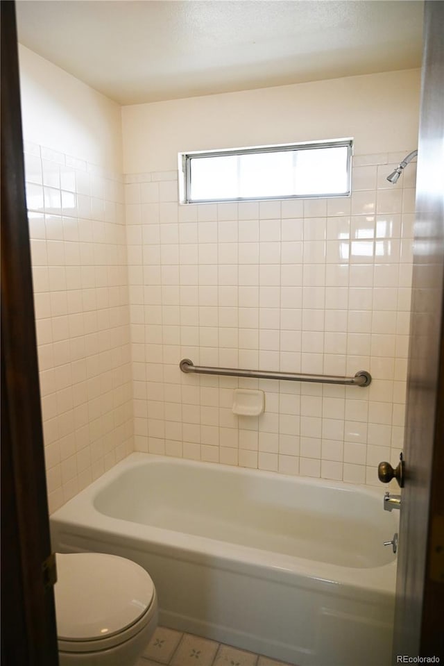 bathroom featuring toilet and tub / shower combination