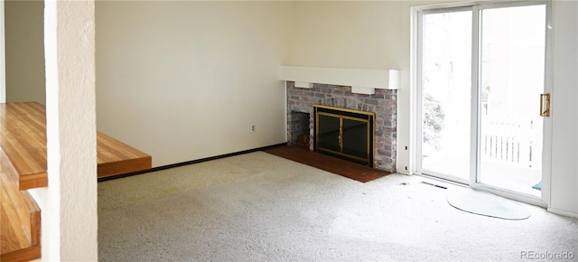 unfurnished living room with a brick fireplace and visible vents