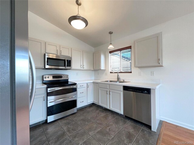 4011 W 28th Street Rd, Greeley, CO 80634 - kitchen featuring appliances with stainless steel finishes, vaulted ceiling, light countertops, and hanging light fixtures