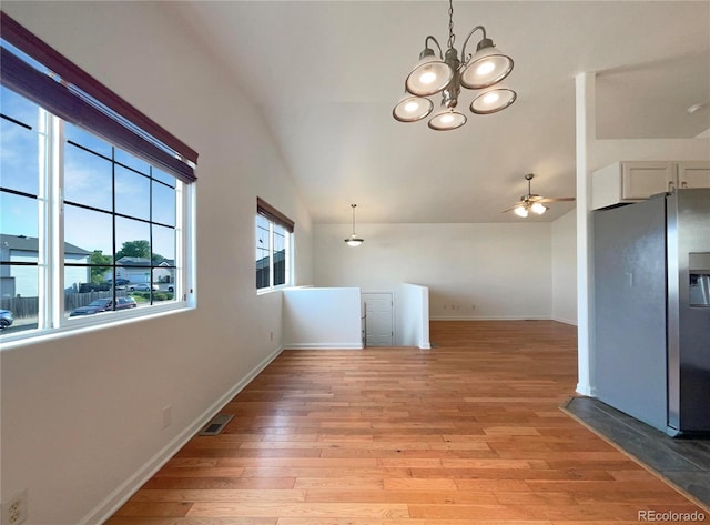 4011 W 28th Street Rd, Greeley, CO 80634 - unfurnished dining area with lofted ceiling, ceiling fan, light wood finished floors, and a chandelier