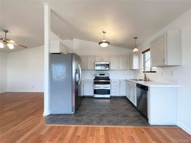 4011 W 28th Street Rd, Greeley, CO 80634 - kitchen featuring appliances with stainless steel finishes, lofted ceiling, ceiling fan, light countertops, and dark wood-style flooring