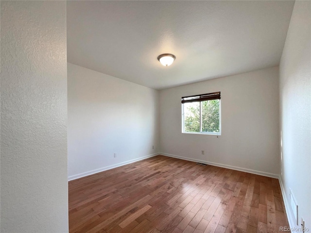 4011 W 28th Street Rd, Greeley, CO 80634 - empty room featuring hardwood / wood-style floors and a textured wall