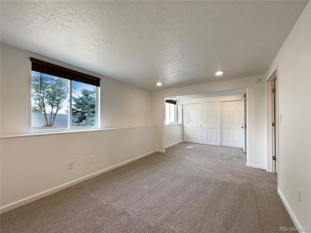 4011 W 28th Street Rd, Greeley, CO 80634 - unfurnished bedroom featuring a textured ceiling, carpet floors, recessed lighting, and a closet
