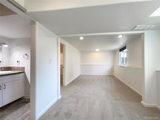4011 W 28th Street Rd, Greeley, CO 80634 - below grade area featuring carpet floors and a textured ceiling