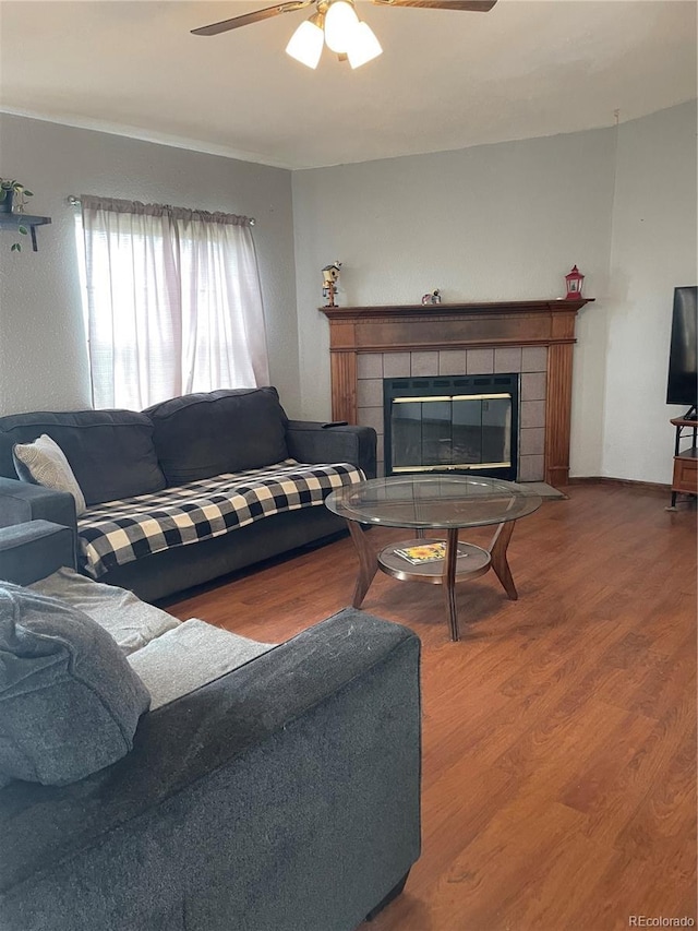 47904 Dartmouth Ave, Bennett, CO 80102 - living room with ceiling fan, a tile fireplace, and wood finished floors