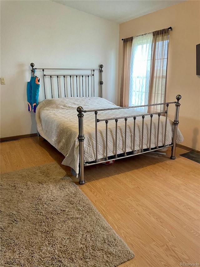 47904 Dartmouth Ave, Bennett, CO 80102 - bedroom featuring wood finished floors and baseboards