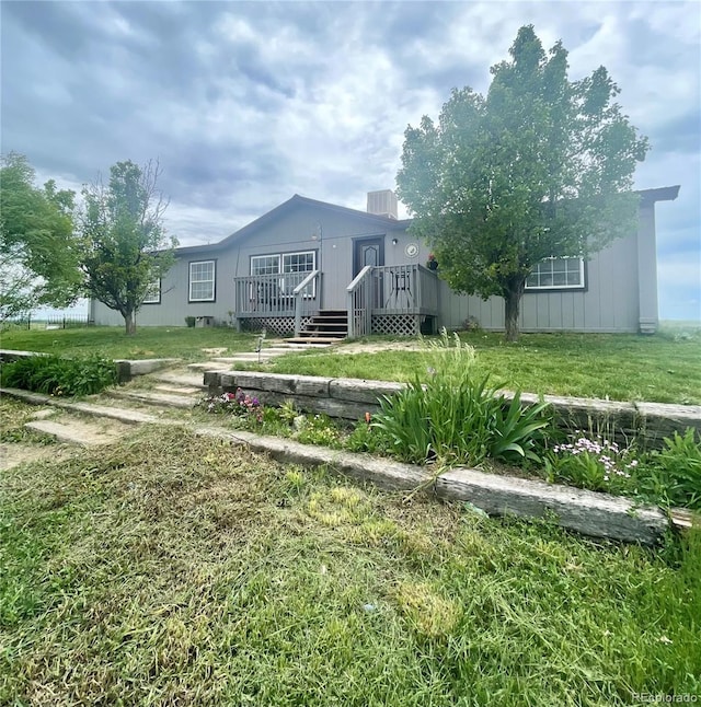 47904 Dartmouth Ave, Bennett, CO 80102 - back of property with a wooden deck and a lawn