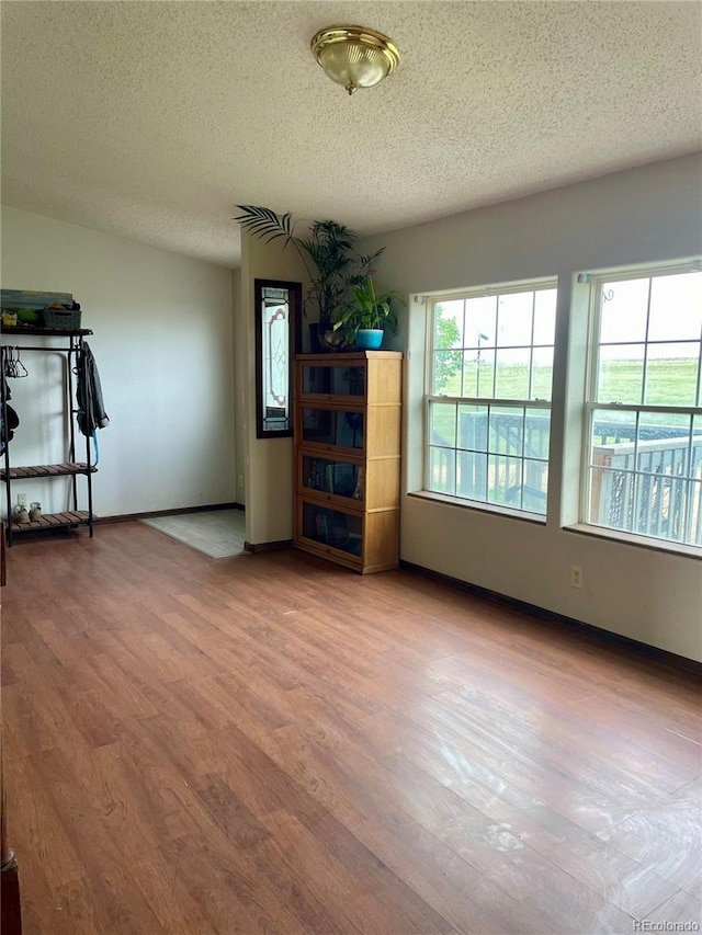 47904 Dartmouth Ave, Bennett, CO 80102 - unfurnished room featuring a textured ceiling, wood finished floors, and baseboards