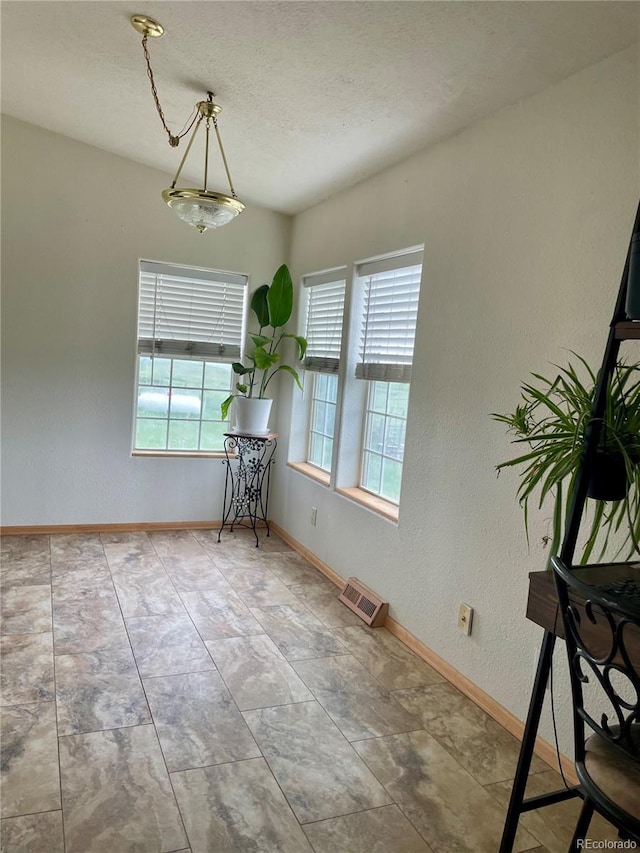47904 Dartmouth Ave, Bennett, CO 80102 - dining space with baseboards and a textured ceiling