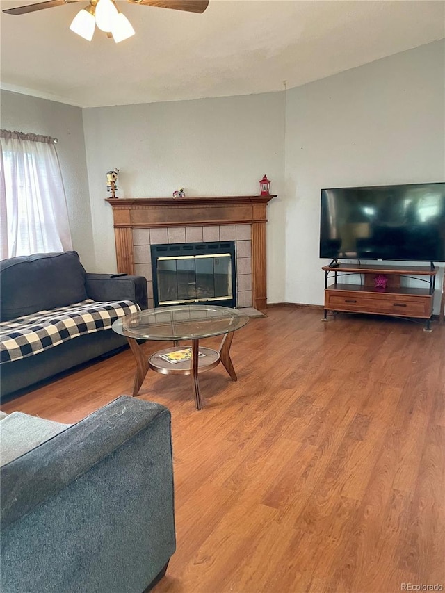47904 Dartmouth Ave, Bennett, CO 80102 - living area featuring a ceiling fan, a fireplace, and wood finished floors