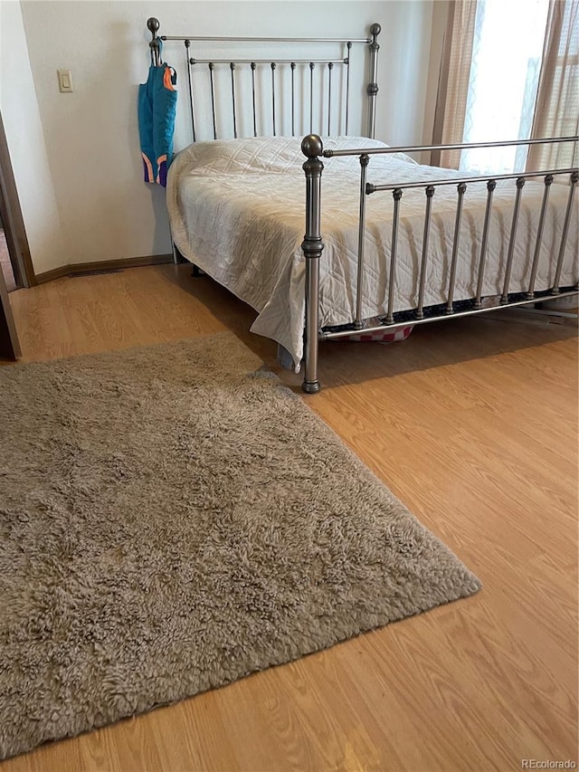 47904 Dartmouth Ave, Bennett, CO 80102 - bedroom with wood finished floors and baseboards