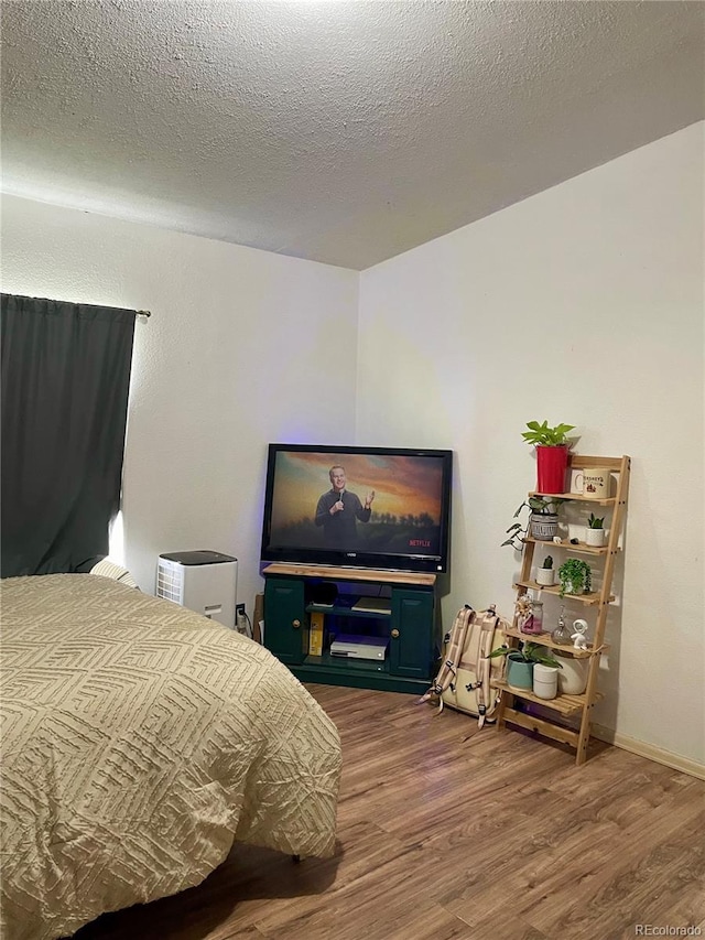 47904 Dartmouth Ave, Bennett, CO 80102 - bedroom with wood finished floors and a textured ceiling