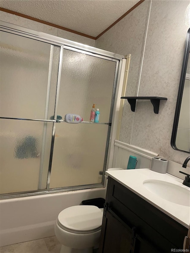47904 Dartmouth Ave, Bennett, CO 80102 - full bath with vanity, ornamental molding, toilet, bath / shower combo with glass door, and a textured ceiling