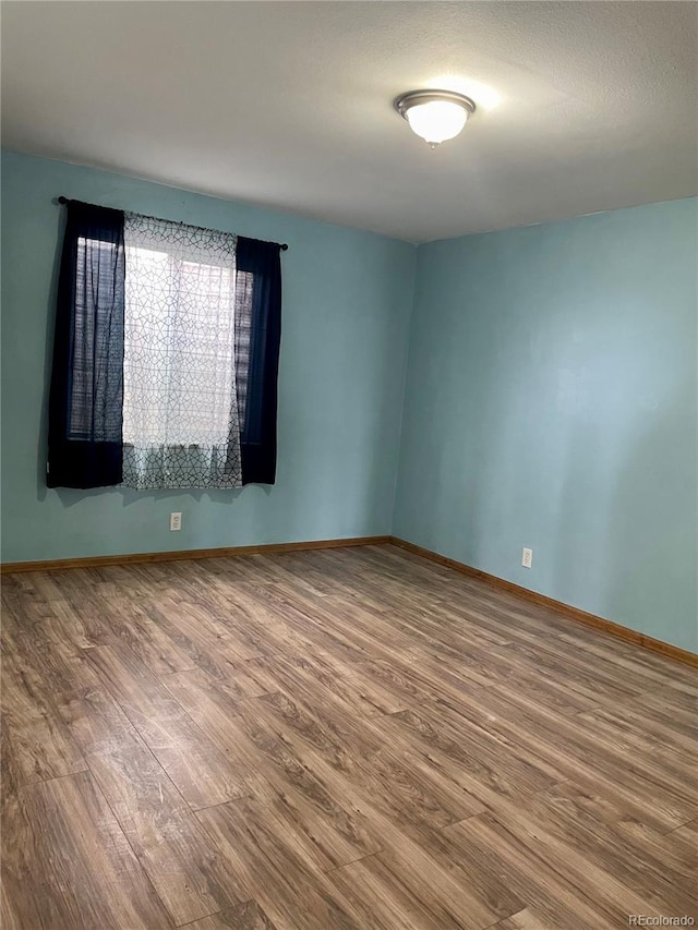 47904 Dartmouth Ave, Bennett, CO 80102 - unfurnished room featuring wood finished floors and baseboards