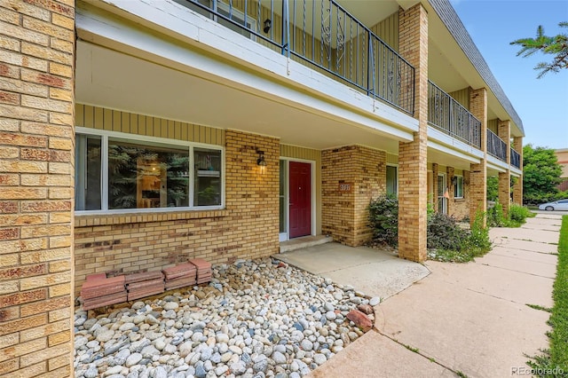 6727 S Race St, Centennial, CO 80122 - property entrance featuring brick siding and a balcony