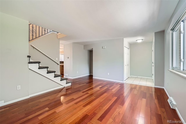6727 S Race St, Centennial, CO 80122 - unfurnished living room with hardwood / wood-style flooring and stairway