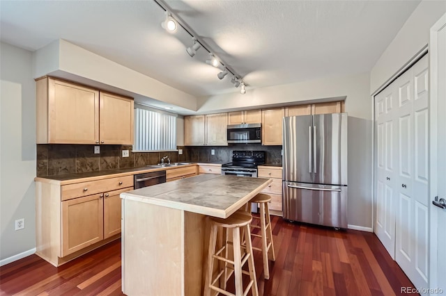 6727 S Race St, Centennial, CO 80122 - kitchen with appliances with stainless steel finishes, light brown cabinetry, and dark wood-style floors