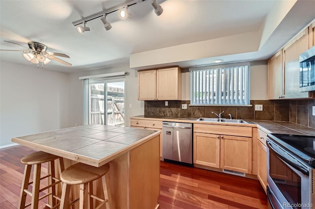 6727 S Race St, Centennial, CO 80122 - kitchen with appliances with stainless steel finishes, tile counters, light brown cabinets, and dark wood finished floors