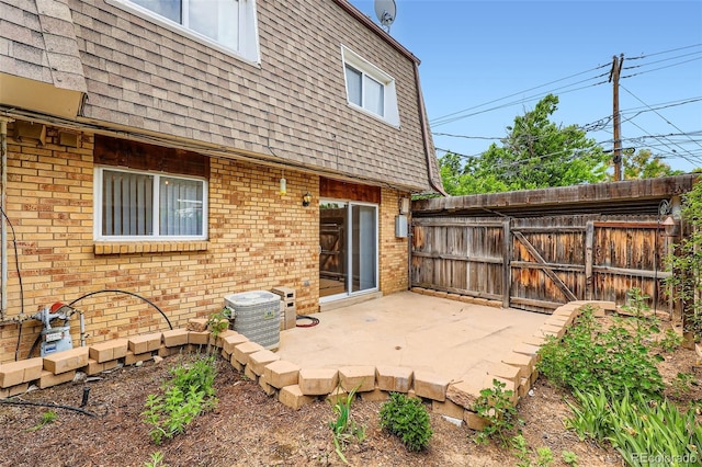 6727 S Race St, Centennial, CO 80122 - back of house with a patio, roof with shingles, brick siding, and mansard roof