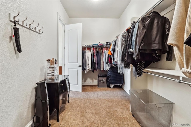 walk in closet with carpet flooring