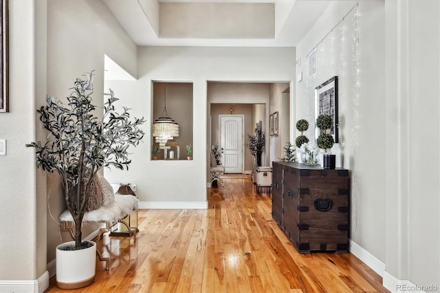 hall featuring baseboards and light wood-style floors