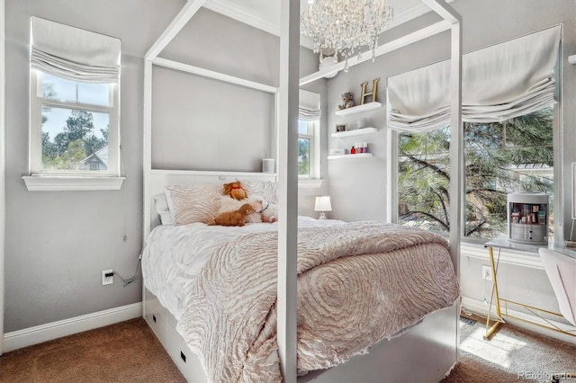 carpeted bedroom featuring a notable chandelier and baseboards