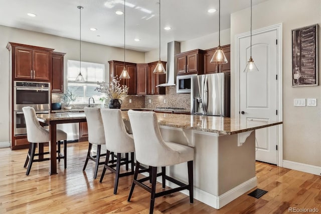 6875 Northstar Ct, Castle Rock, CO 80108 - kitchen featuring stainless steel appliances, backsplash, a kitchen island, a breakfast bar, and recessed lighting