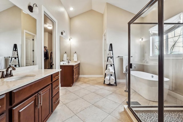 6875 Northstar Ct, Castle Rock, CO 80108 - full bath with two vanities, a soaking tub, a shower stall, lofted ceiling, and baseboards