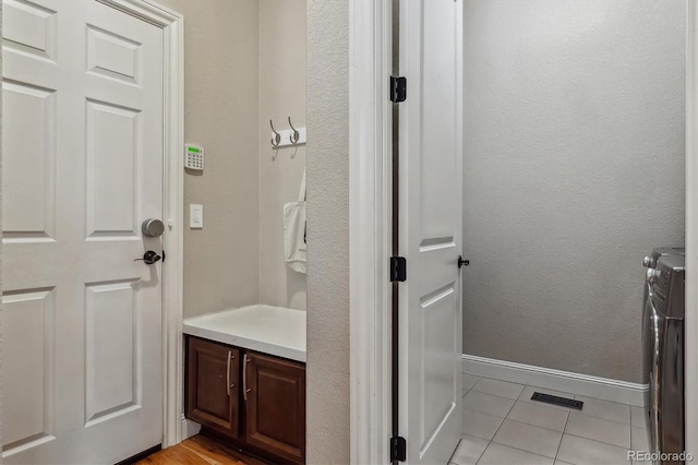 6875 Northstar Ct, Castle Rock, CO 80108 - bathroom featuring tile patterned flooring, washer and clothes dryer, baseboards, and vanity