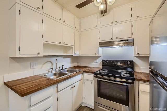 kitchen featuring stainless steel refrigerator, wood counters, ceiling fan, sink, and range with electric stovetop