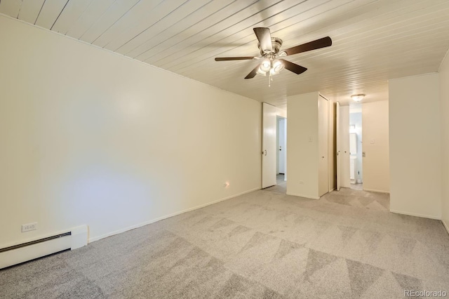 unfurnished bedroom featuring ceiling fan, a baseboard heating unit, and light carpet