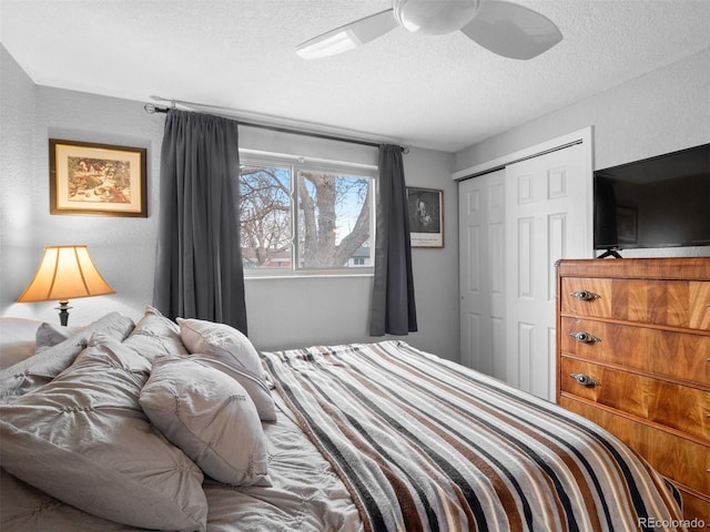 bedroom with a ceiling fan, a closet, and a textured ceiling