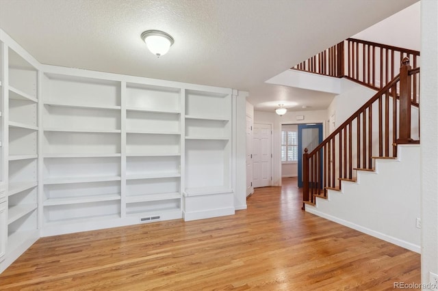 interior space featuring light hardwood / wood-style floors and a textured ceiling