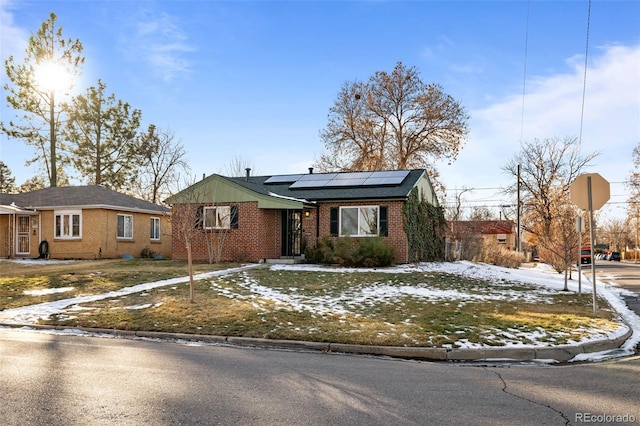 single story home featuring solar panels