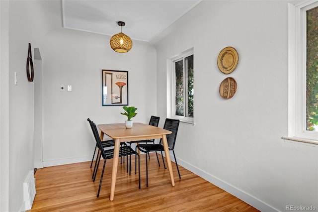 dining space with plenty of natural light and light hardwood / wood-style flooring