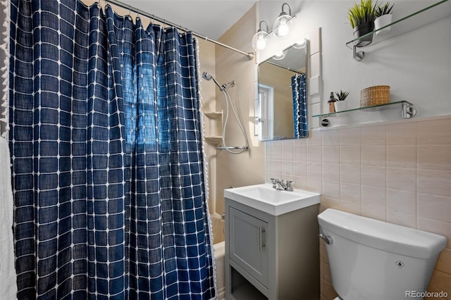 full bathroom with tile walls, toilet, decorative backsplash, shower / bath combo with shower curtain, and vanity