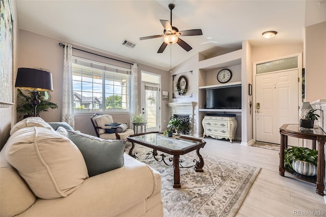 10467 W Hampden Ave Unit 204, Lakewood, CO 80227 - living area featuring ceiling fan, light wood-style flooring, lofted ceiling, and a fireplace