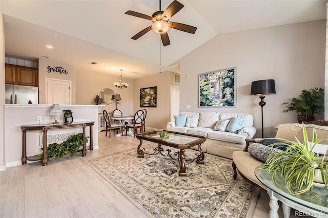 10467 W Hampden Ave Unit 204, Lakewood, CO 80227 - living area with a ceiling fan, vaulted ceiling, light wood-type flooring, and a chandelier