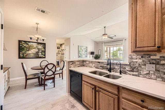 10467 W Hampden Ave Unit 204, Lakewood, CO 80227 - kitchen featuring black dishwasher, backsplash, brown cabinets, a chandelier, and light stone counters